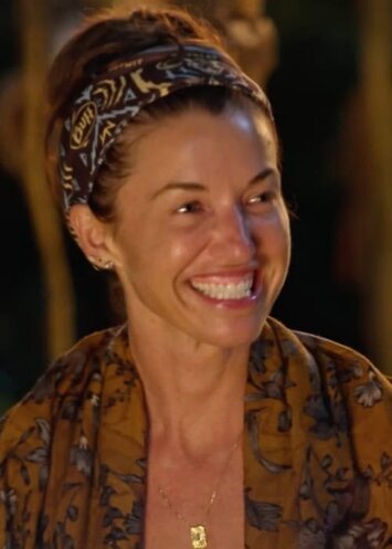 Smiling woman enjoying a moment outdoors at night, representing reality TV drama, happiness