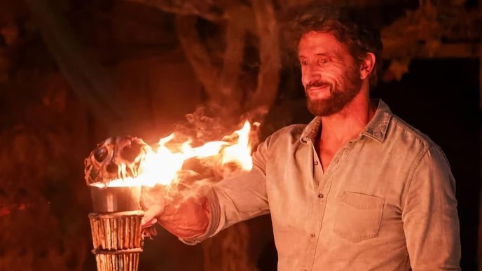 A man snuffs out a torch