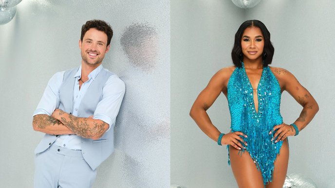 Man with tattoos wearing a light blue suit, standing confidently in front of a textured wall; woman in a sequined gymnast uniform posing with hands on hips