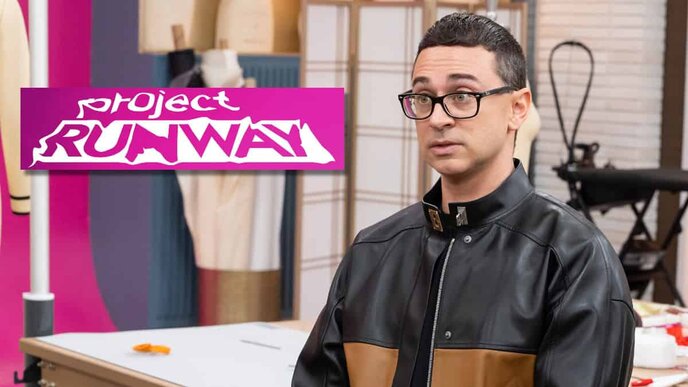 A man with glasses and a black and brown leather jacket stands in a room with a 'Project Runway' sign in the background.